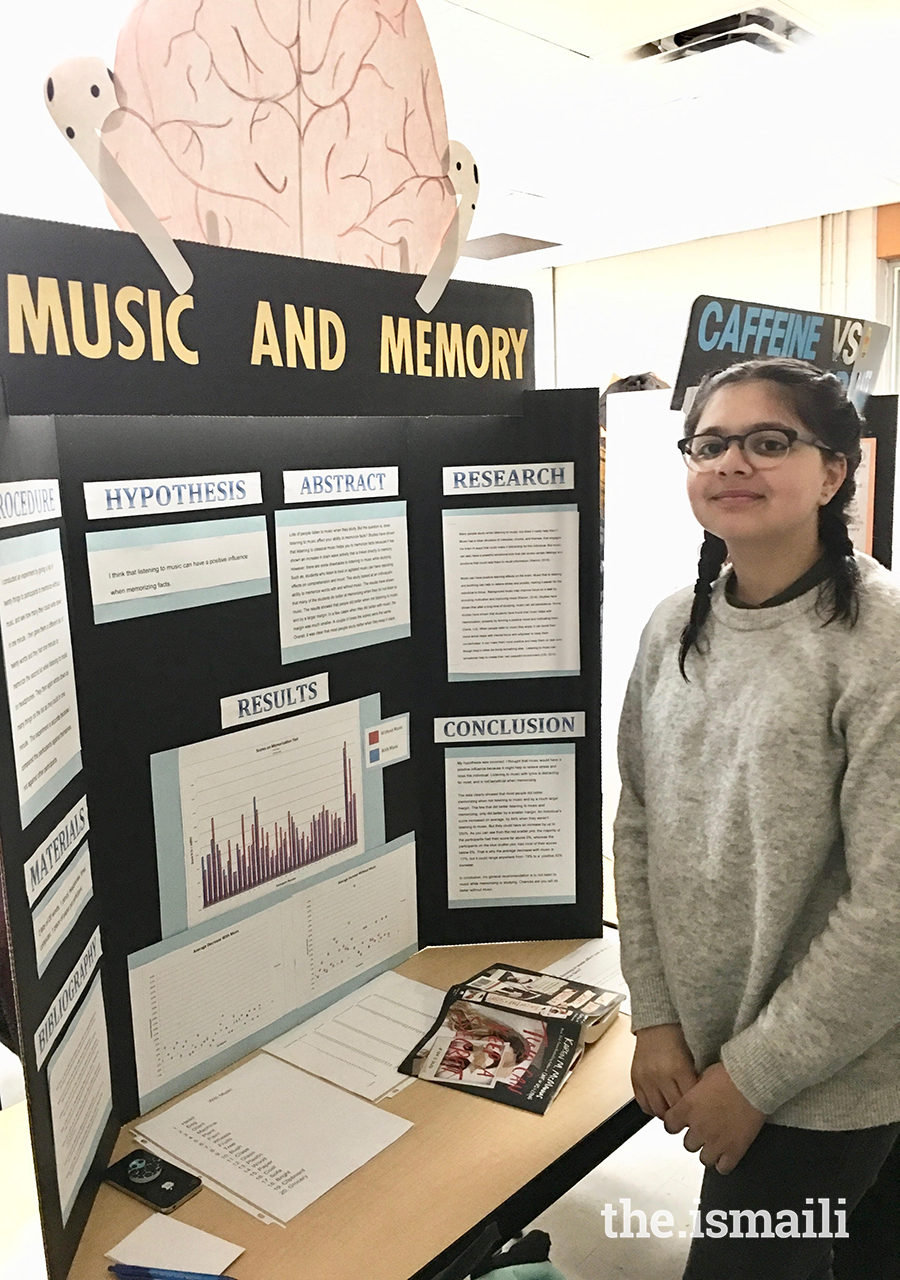 Mishka Nazarani poses next to a display of her music and memory experiment.