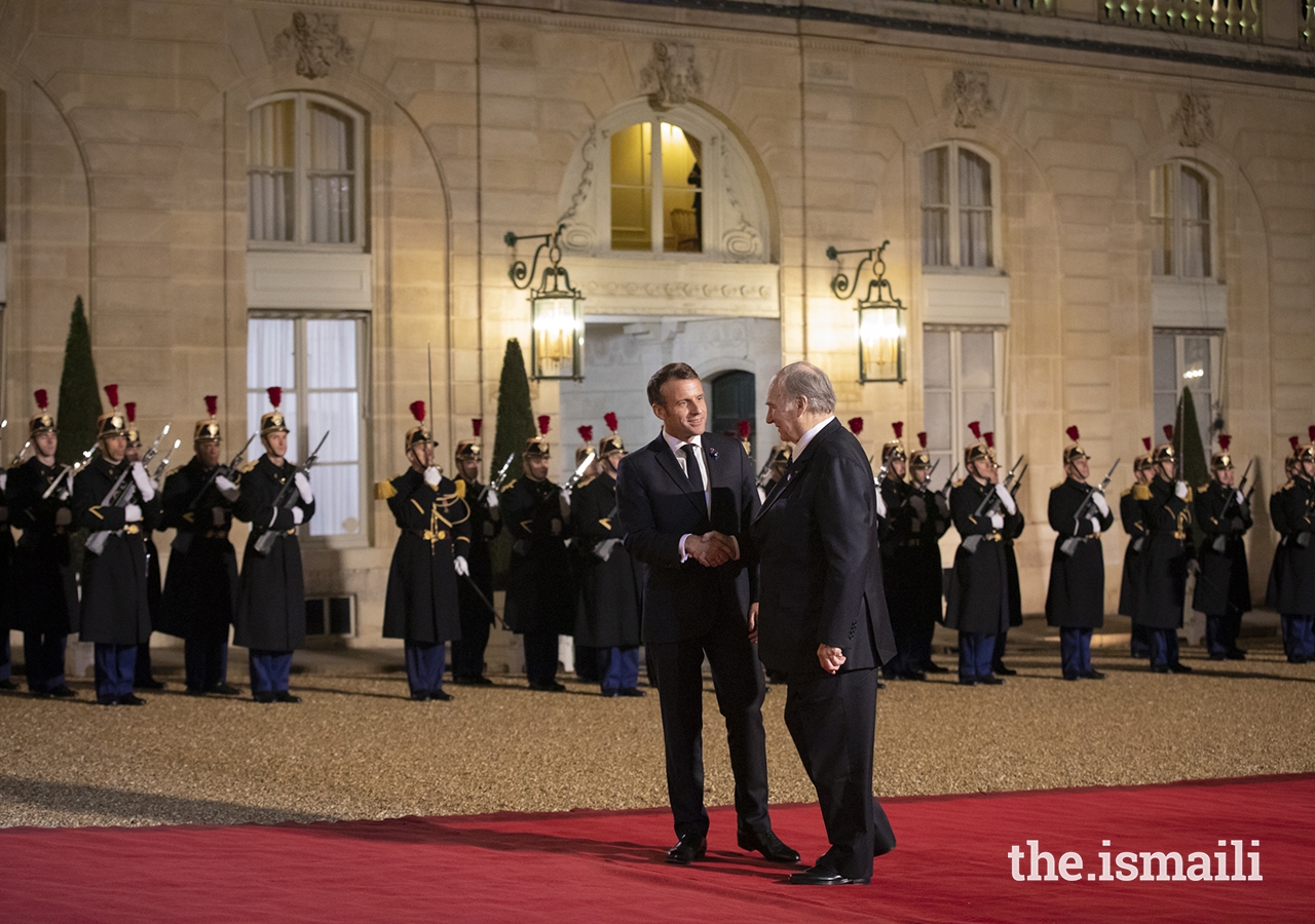President Emmanuel Macron greets Mawlana Hazar Imam in the courtyard of the Élysée Palace.