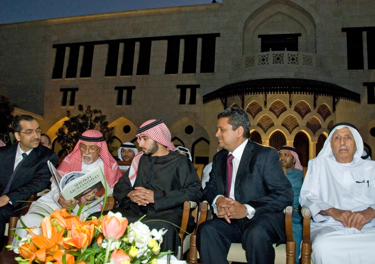 Reviewing a book published by Royal Photographer Noor Ali Rashid in the courtyard of the Ismaili Centre Dubai. From left to right: Vice President Wazir Ali Daredia of the Ismaili Council for UAE, Royal Photographer Noor Ali Rashid, His Highness Sheikh Maj
