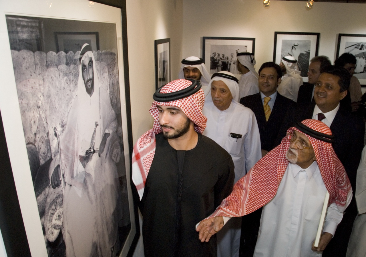 His Highness Sheikh Majid and Noor Ali Rashid  pause at a photograph of the late Ruler of Abu Dhabi, Sheikh Zayed Bin Sultan Al Nahyan.