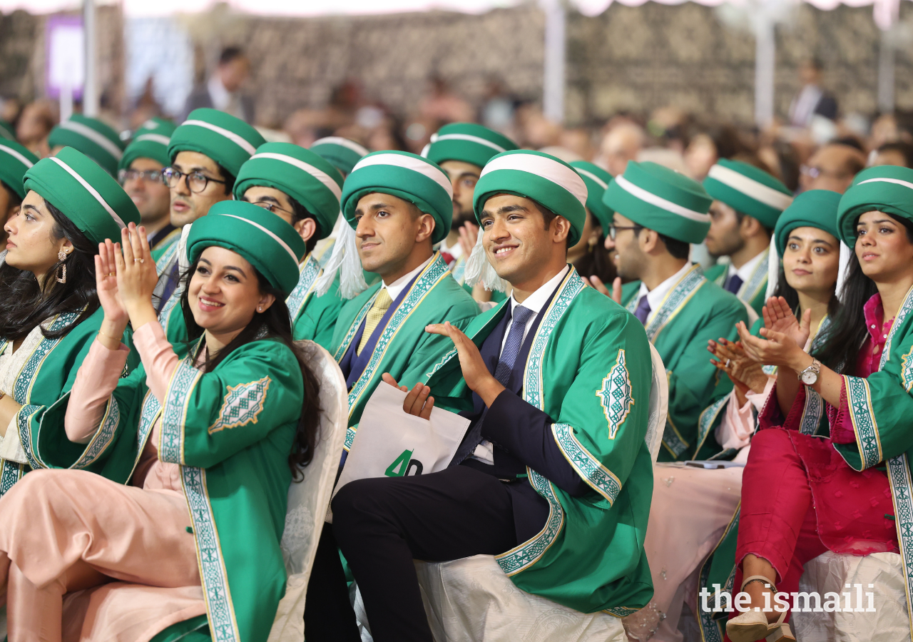 Aga Khan University graduands, dressed in the traditional regalia of green and gold.