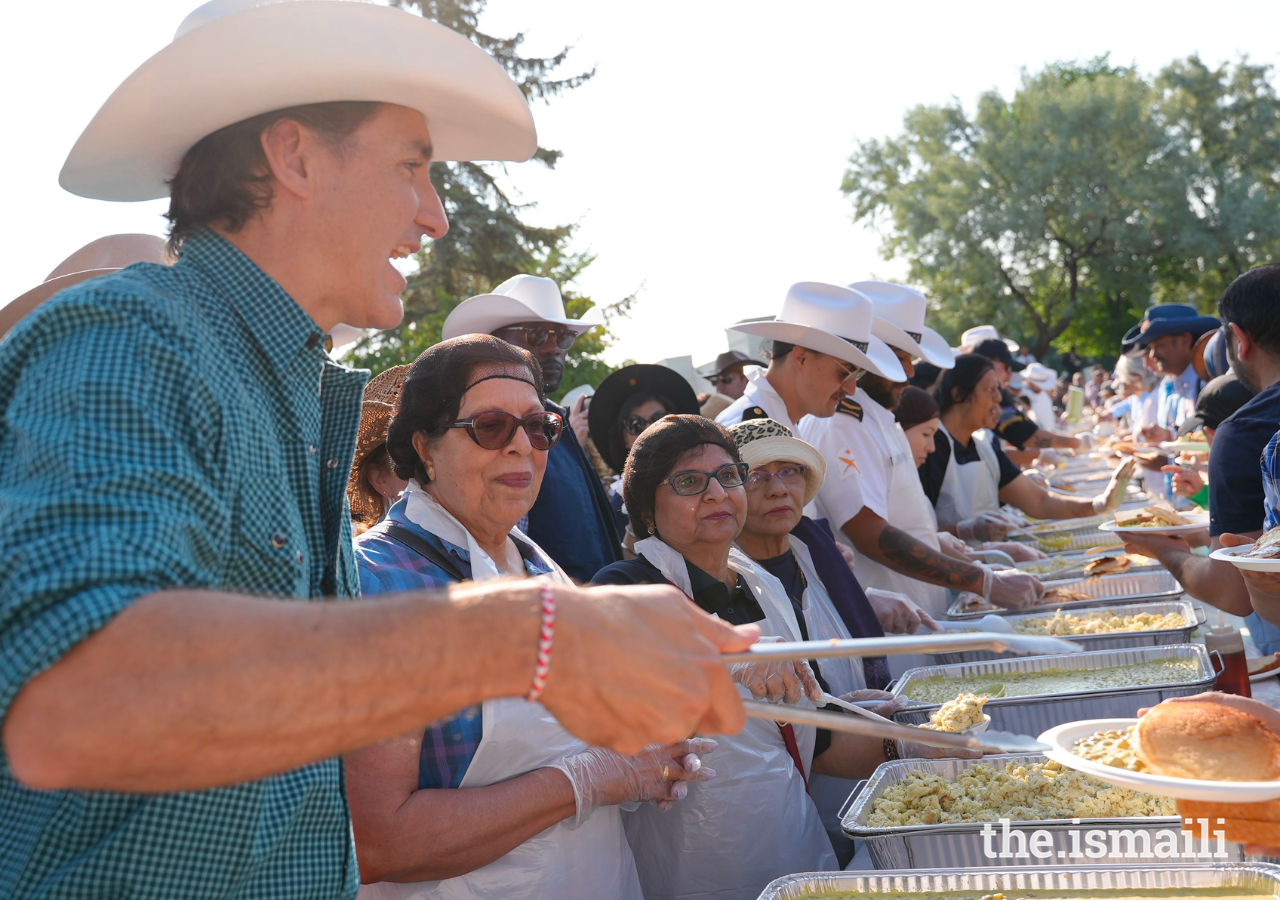 Prime Minister Justin Trudeau offers up pancakes to an excited crowd.