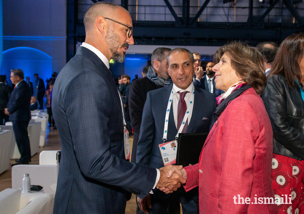 Catherine Colonna, Minister of Europe and Foreign Affairs for France, greets Prince Rahim at the Paris Peace Forum, as Shamir Samdjee, the Ismaili Imamat’s Representative to France, looks on.