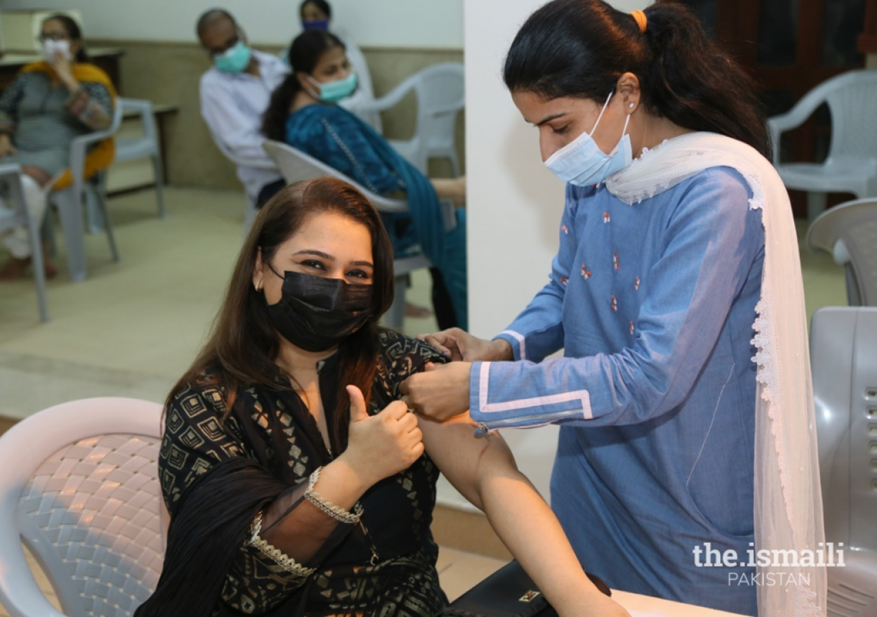 A member of the Jamat expresses happiness after receiving the Covid-19 vaccine.