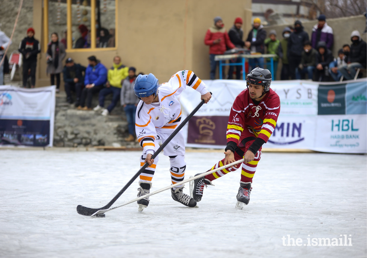 Players from Upper Chitral (white) and SCom (Maroon) vie for the hockey puck during a men’s hockey match at the Winterlude Games in Hunza.