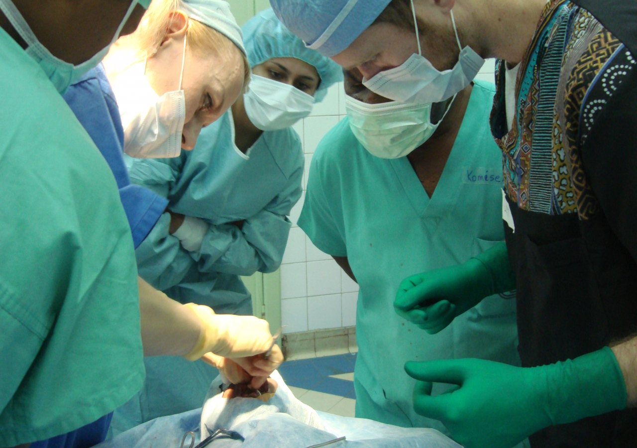 Medical professionals gather in a surgical theatre in Kinshasa to operate on a young patient. In addition to correcting patients’ facial deformities, Operation Smile gives local trainees a chance to learn from experts in their field.