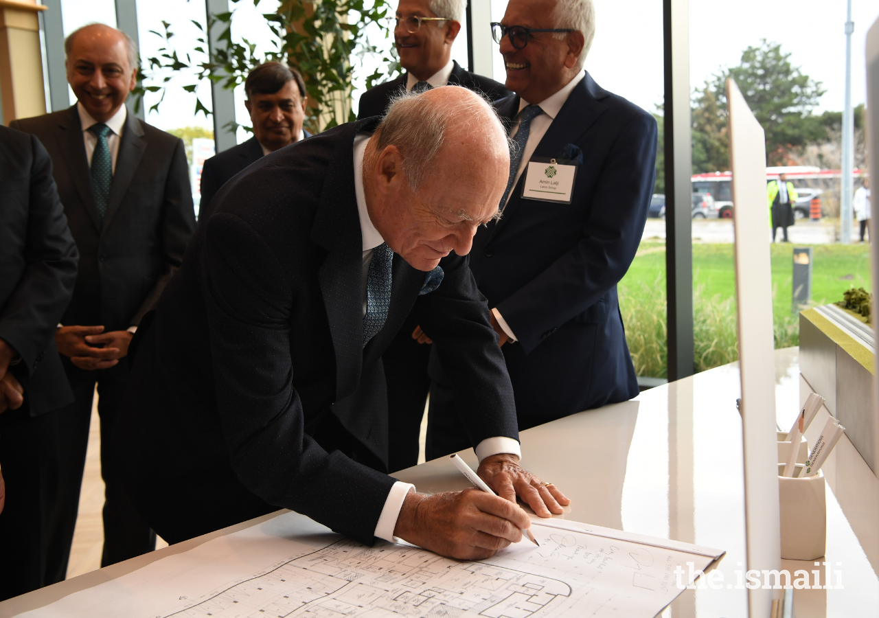 Prince Amyn signs the architectural drawings for Generations Toronto on 27 September 2022.