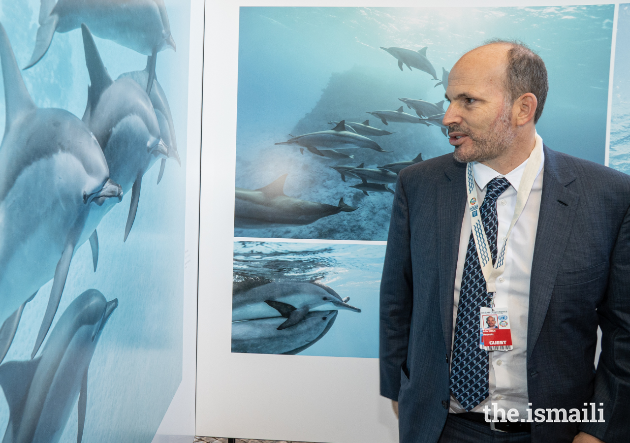 Prince Hussain explains the story behind one of his photographs in the Fragile Beauty exhibition at the United Nations Ocean Conference in Lisbon on 27 June 2022.