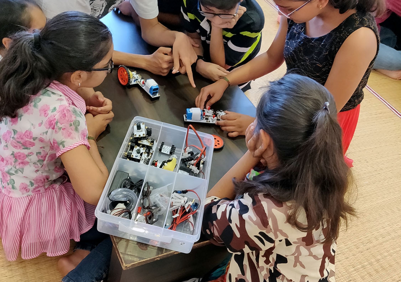 Children engrossed in creating their mini robots