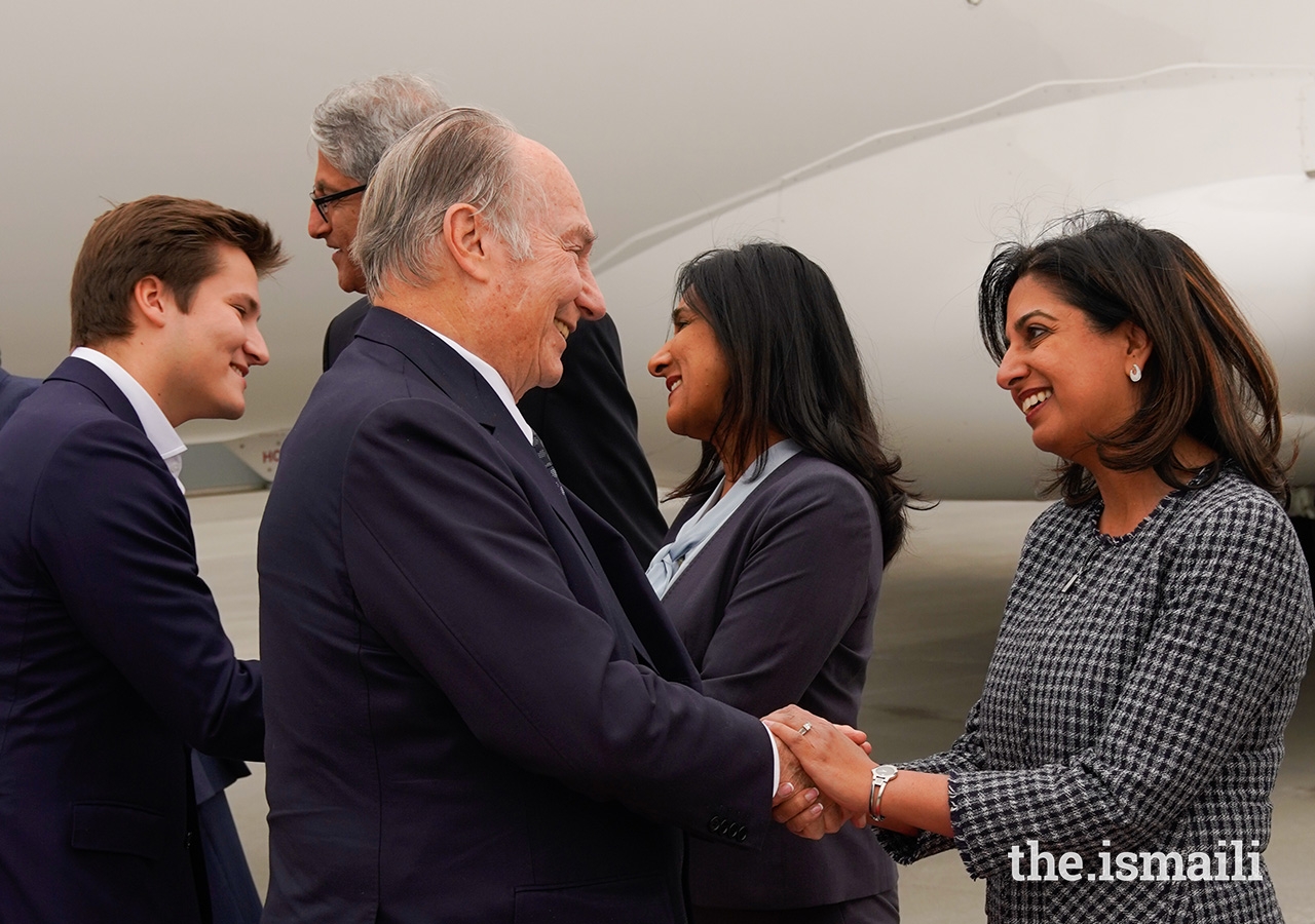 Mawlana Hazar Imam is greeted by President of the Ismaili Council for Edmonton, Zahra Somani, upon arriving in Edmonton for the inauguration of the Aga Khan Garden, accompanied by Prince Aly Muhammad.