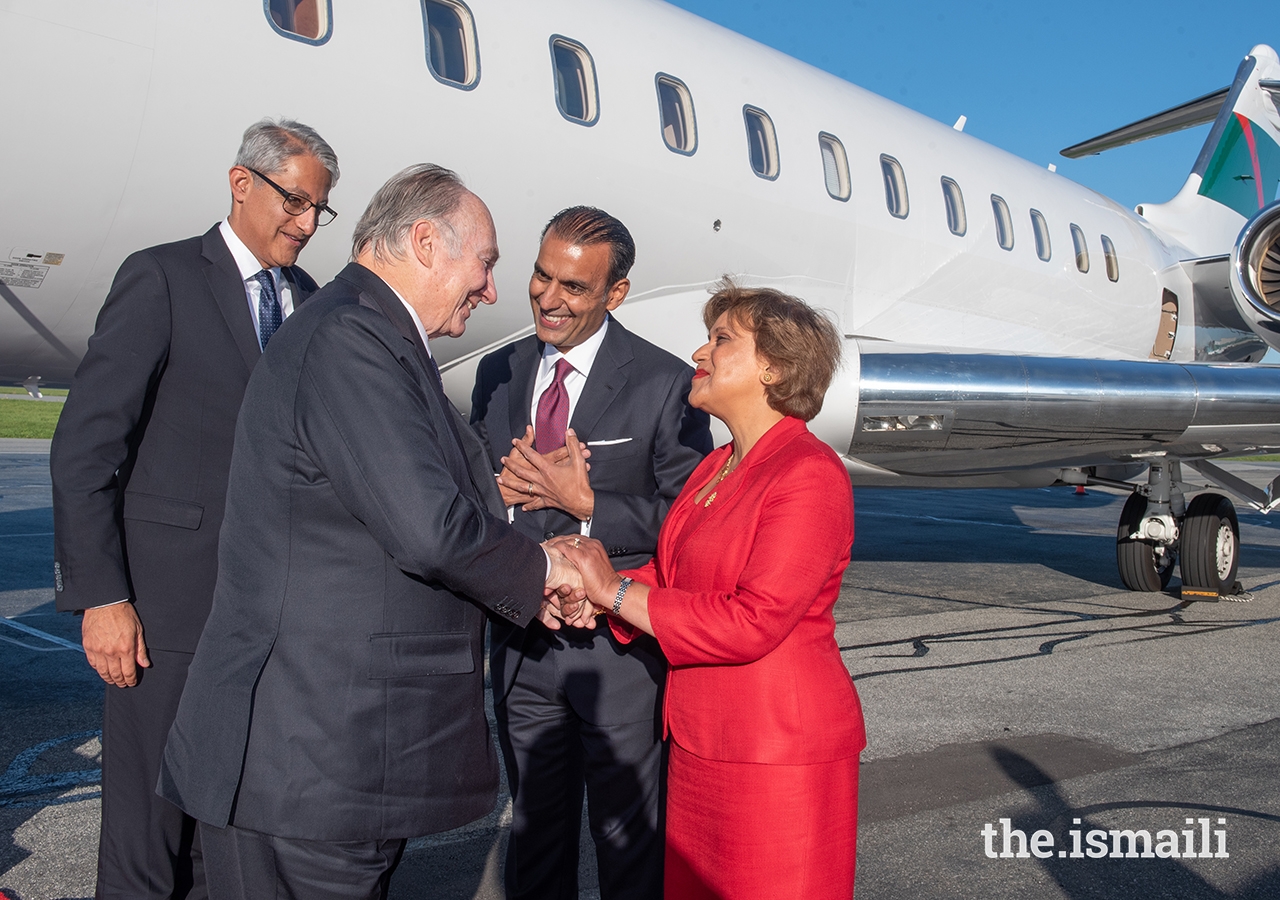 Upon his arrival in Vancouver, Mawlana Hazar Imam is greeted by Samir Manji, President of the Ismaili Council for British Columbia, and Zulie Sachedina, Chair of the International Conciliation and Arbitration Board.