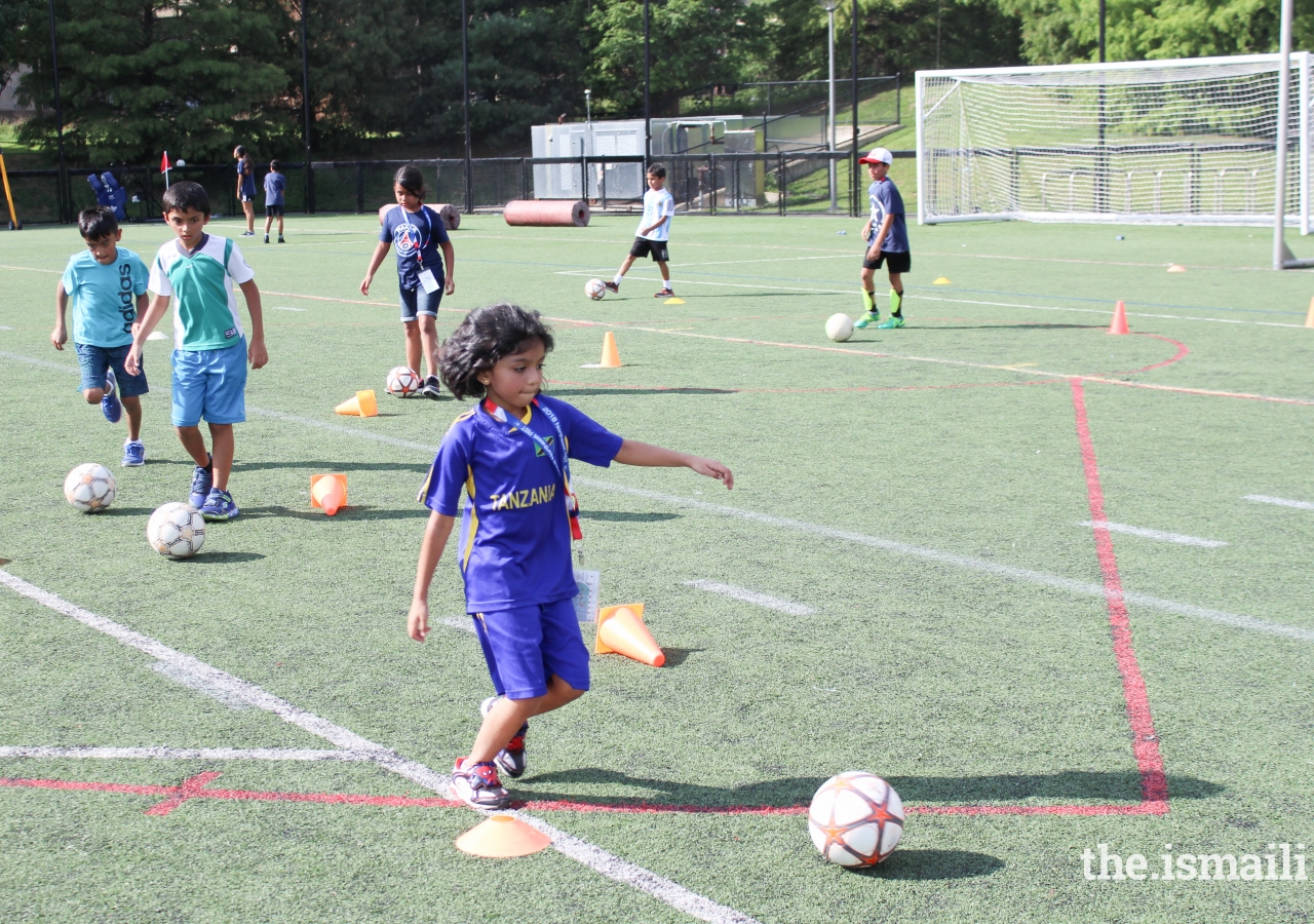 Young children participate in a professionally coached soccer clinic held at the Tournament.