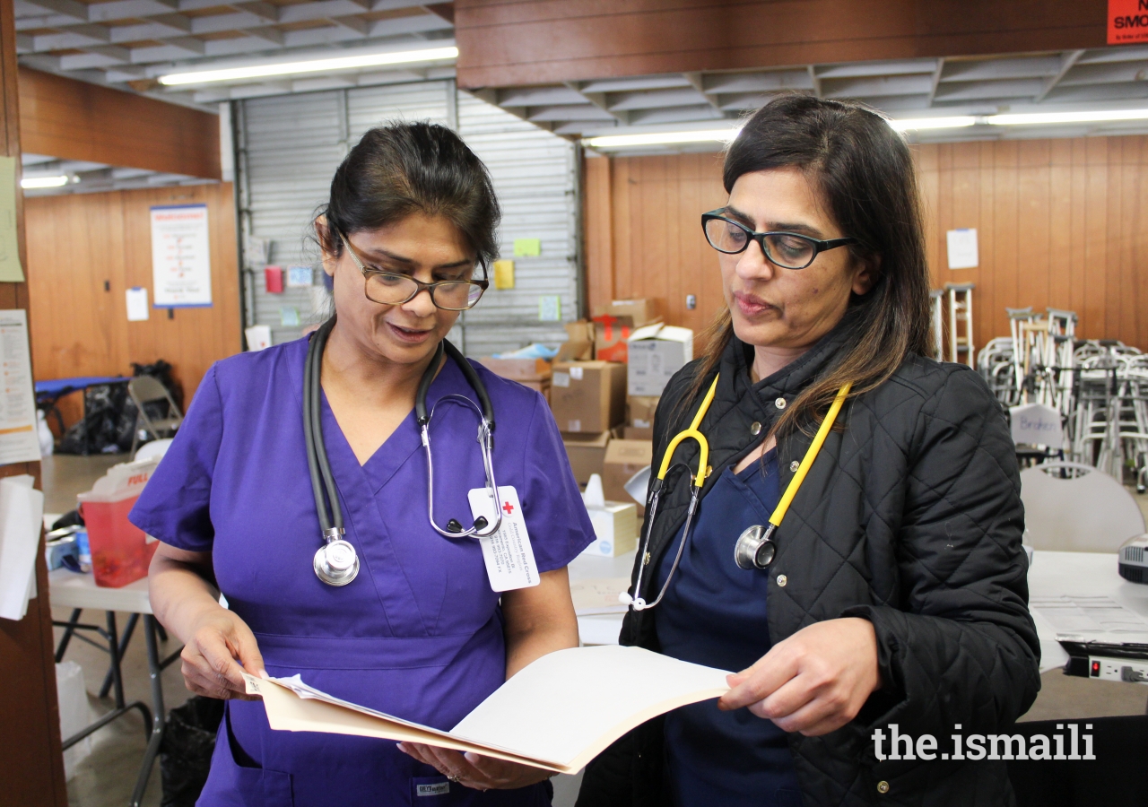 AKU nurses Salima Pirani (Dallas) and Amina Huda (California) review patient records during their volunteer shift.