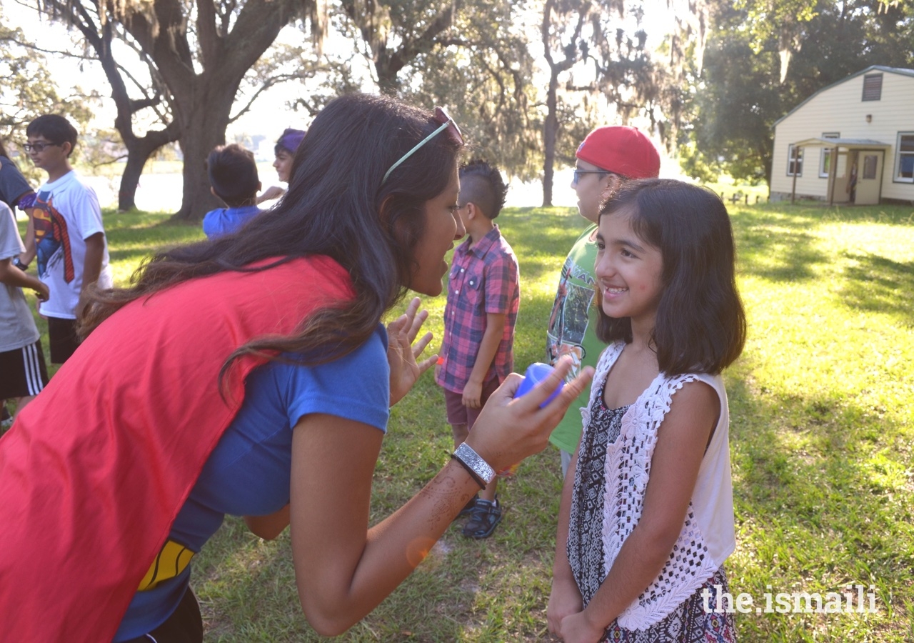 On Superhero day, a counselor engages with her participant one-on-one during sports.