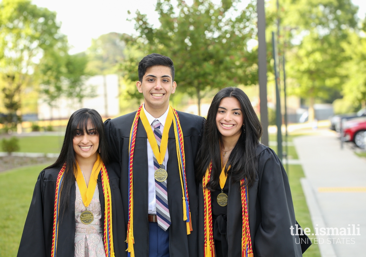 Alma, Aqil, and Anusha Merchant pose for a sibling photo at their high school graduation.
