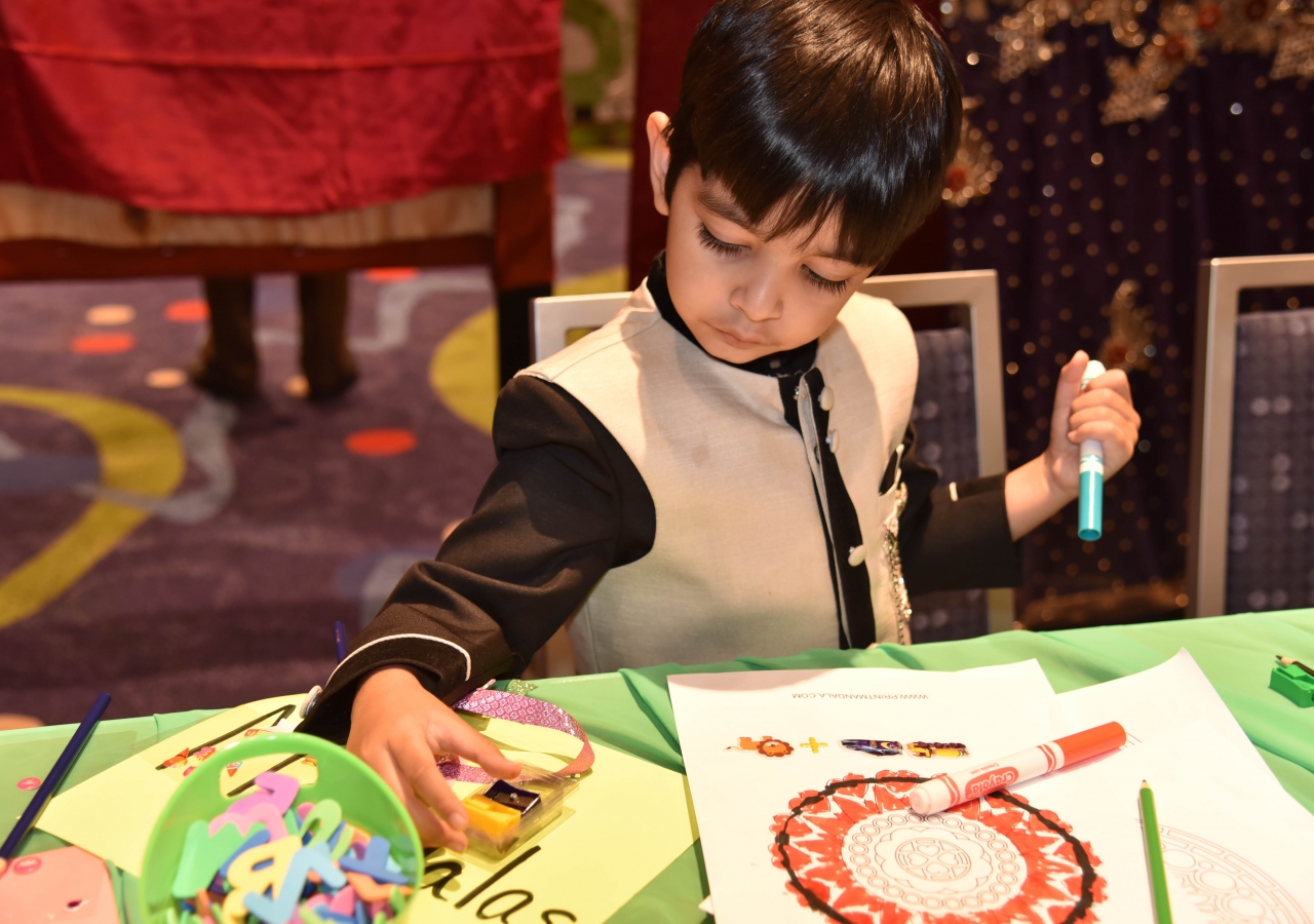 A young boy colors in the Early Childhood section of the Reflections Lounge on July 11, 2017.