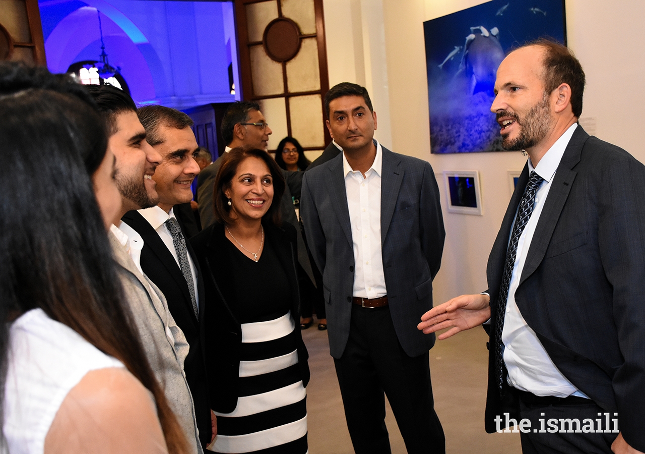 Prince Hussain in conversation with guests at an event hosted by the Aga Khan Council for Kenya, featuring an exhibition of his marine photography and cultural performances.