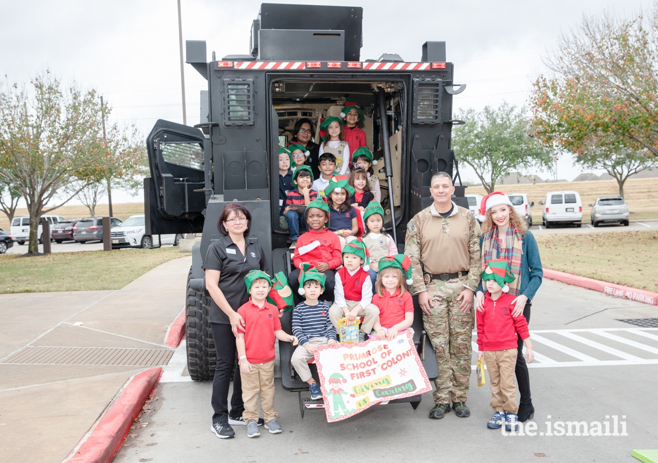 The Primrose School of First Colony posing with a SWAT officer of the Sugar Land Police Department
