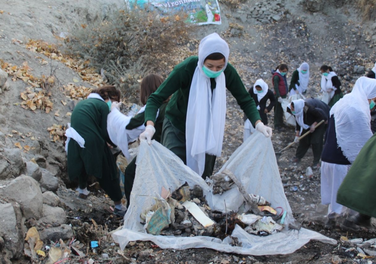 Gilgit Baltistani school girls cleaning the garbages thrown by tourist