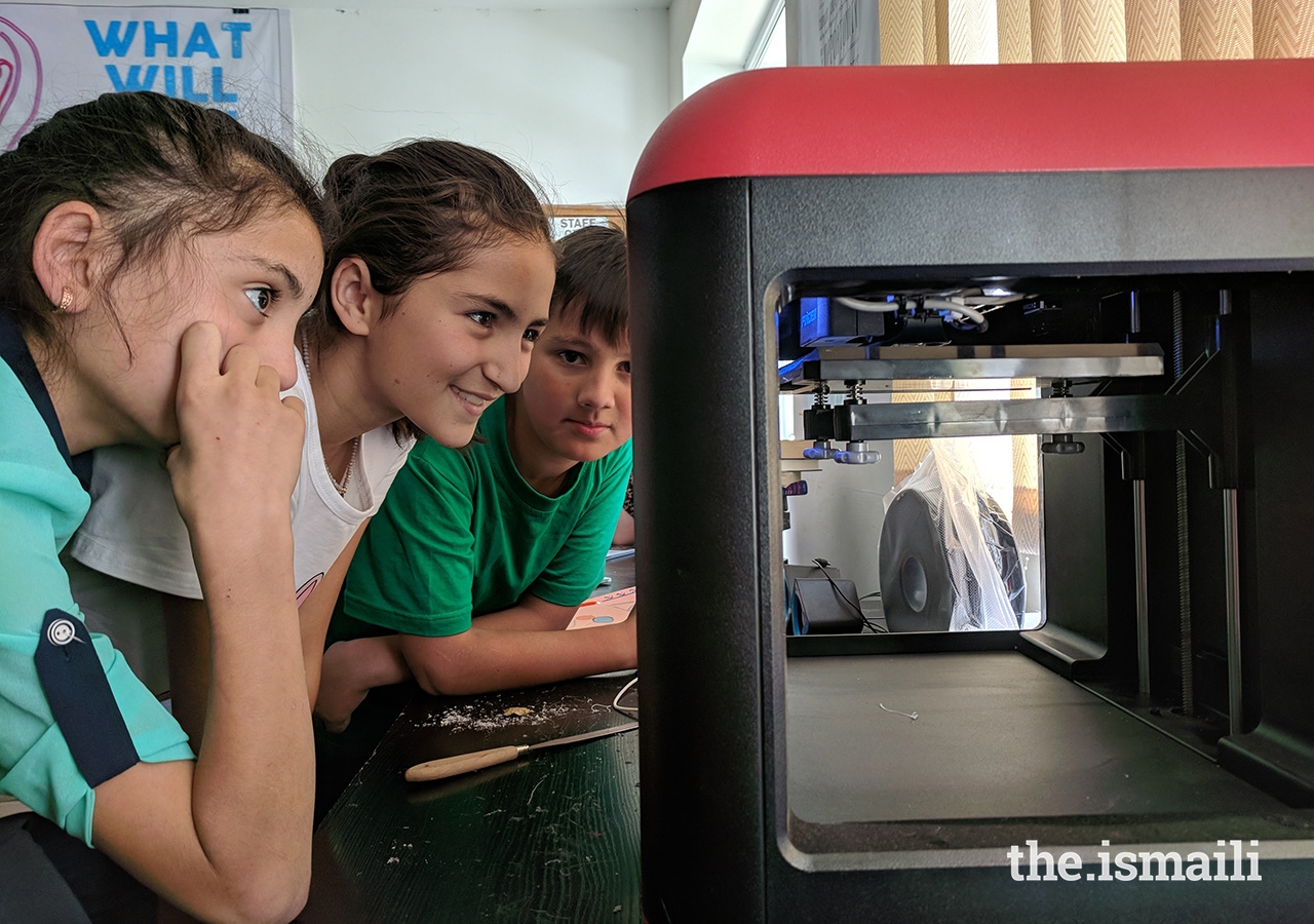 Students watch as the first 3D printer in all of Badakhshan province begins to print a model.