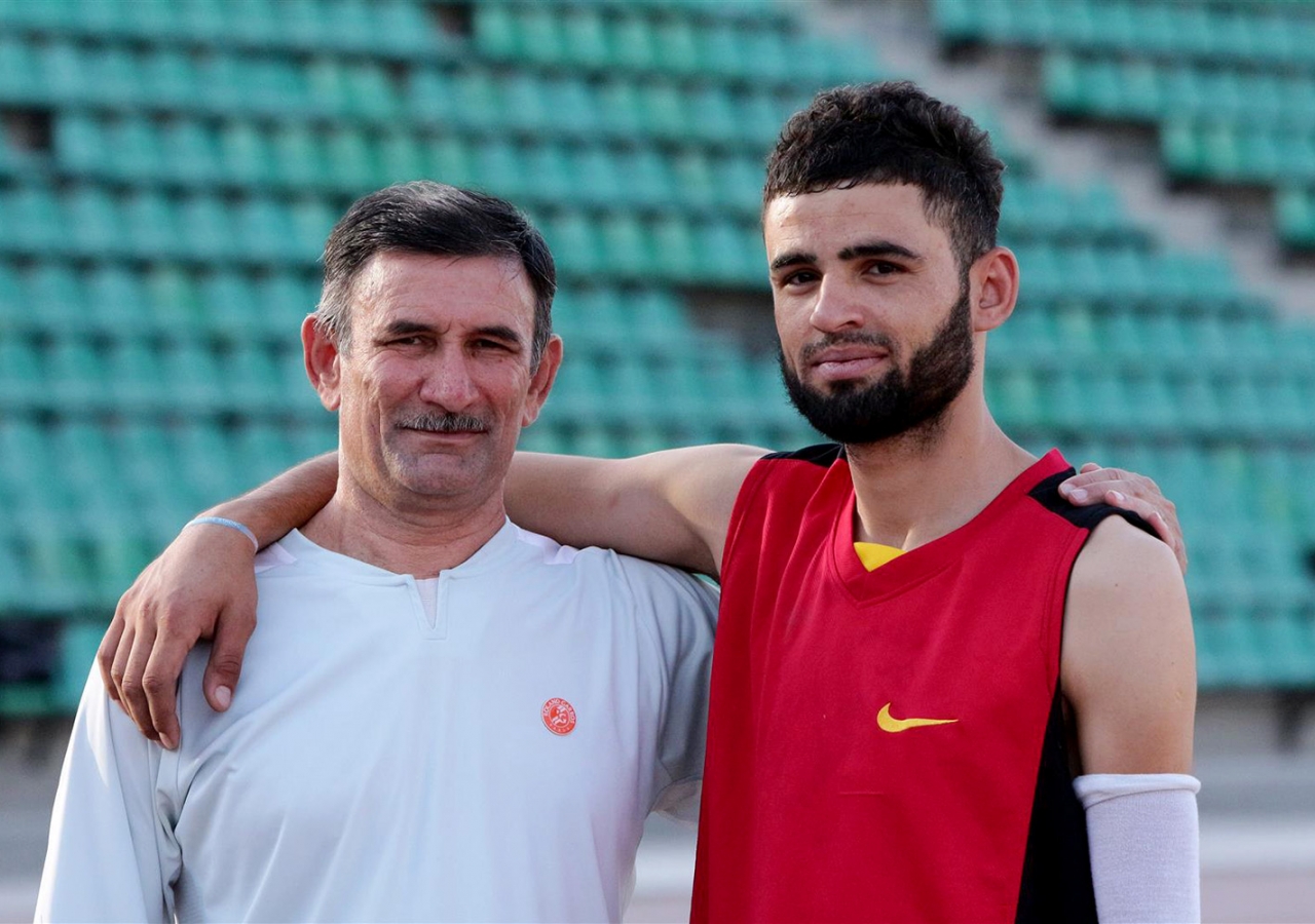 Tajik athlete Romikhudo Dodikhudoev with his trainer, Gairat Negmatov. Muboraksho Guljonov