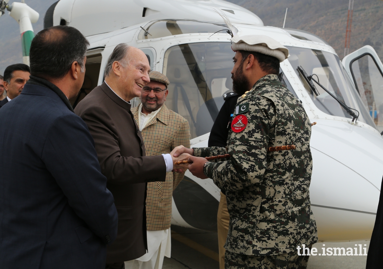 Mawlana Hazar Imam is greeted by Colonel Moinuddin, Commandant Chitral Scouts, upon his arrival at the Chitral Town Airport