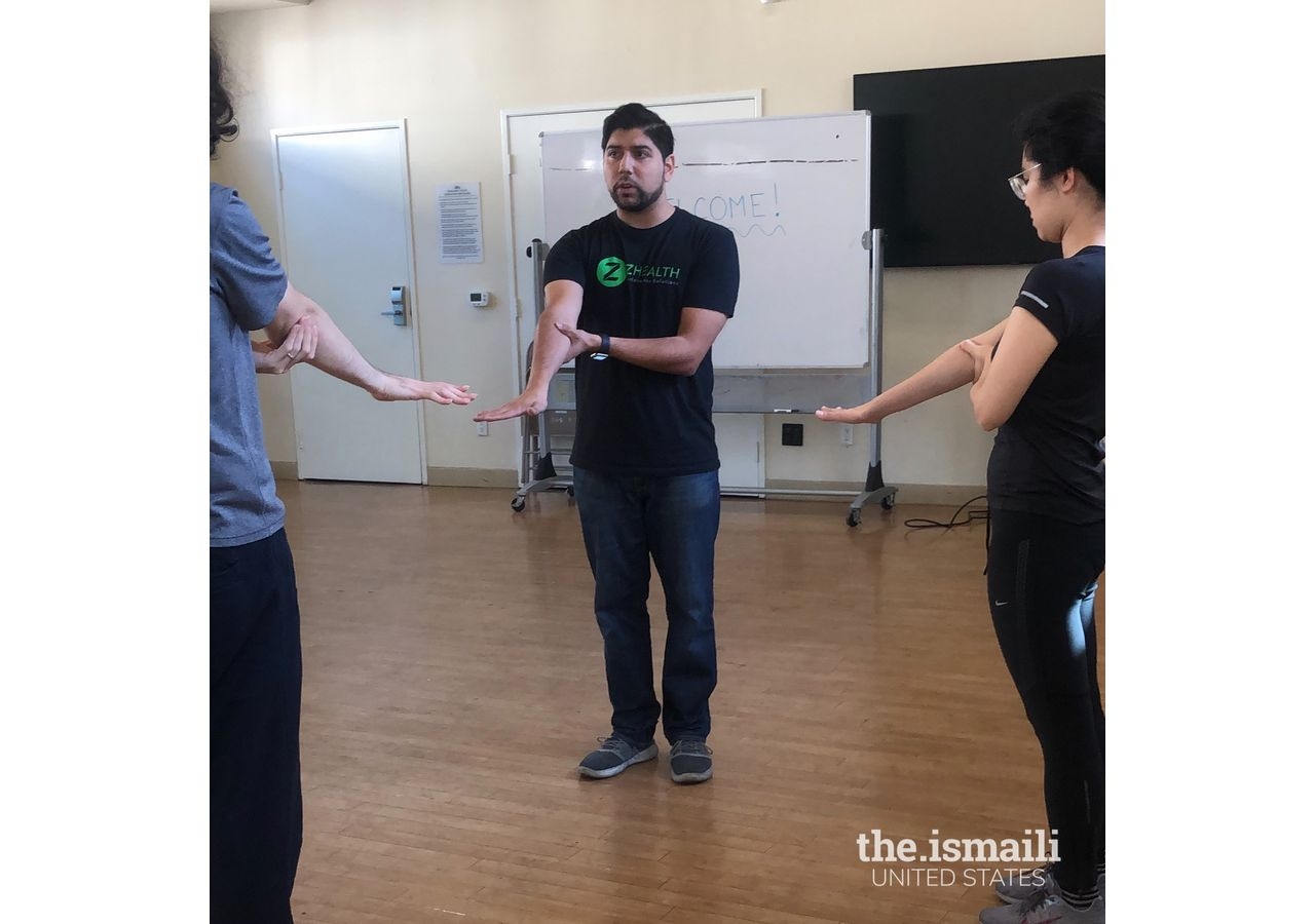 Shawn Lopez illustrating some of his mobility exercises for an Aga Khan Youth and Sports Board program.