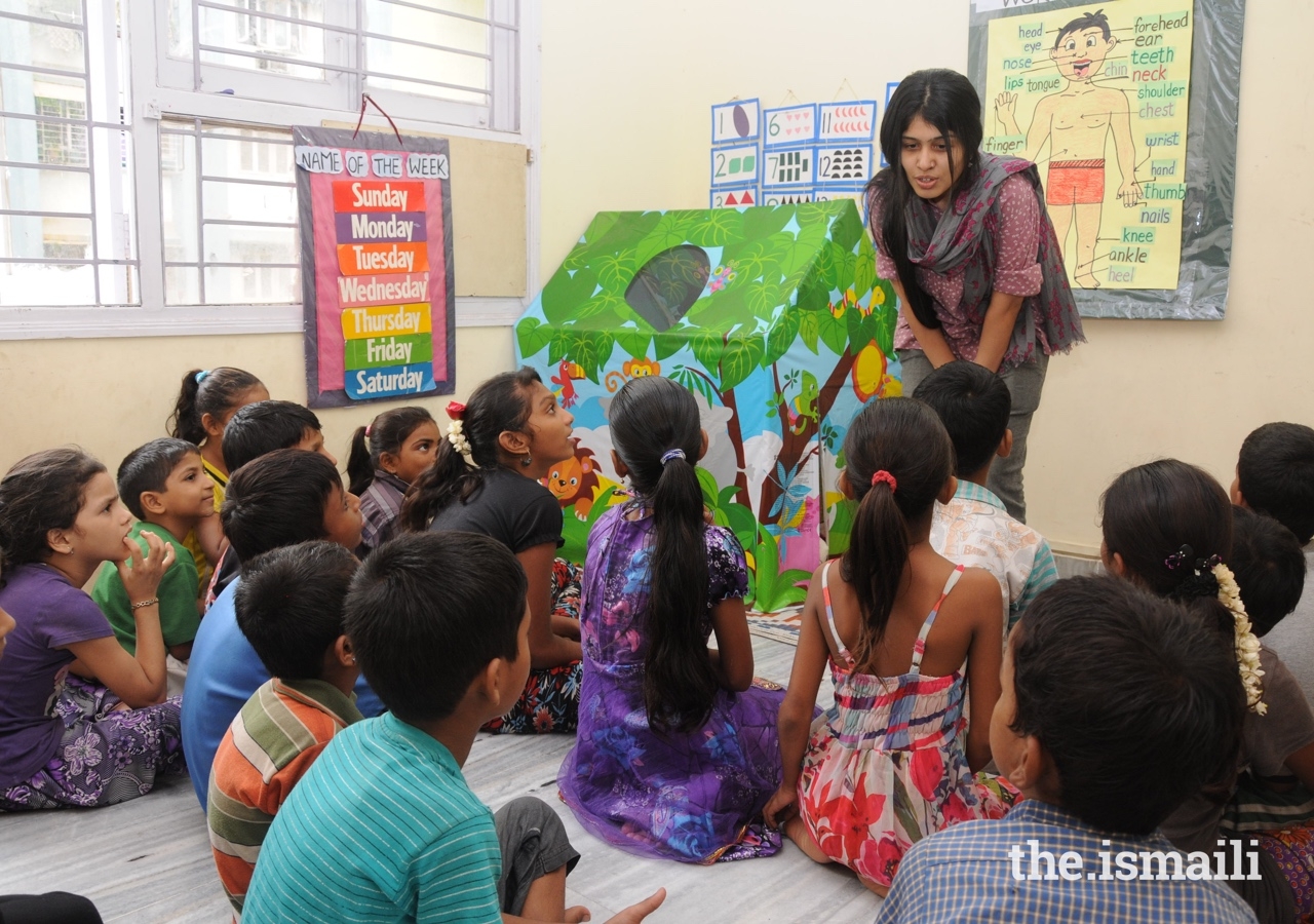 Children listen attentively to Sonia Mackwani during a storytelling session.
