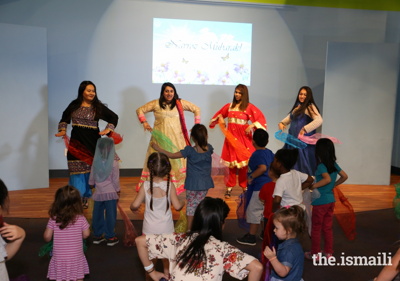 Ismaili volunteers, Farishta Saba, Zohra Nayani, Farheen Hasham, and Amber Kaisani lead a traditional Pamiri dance with silk scarves.