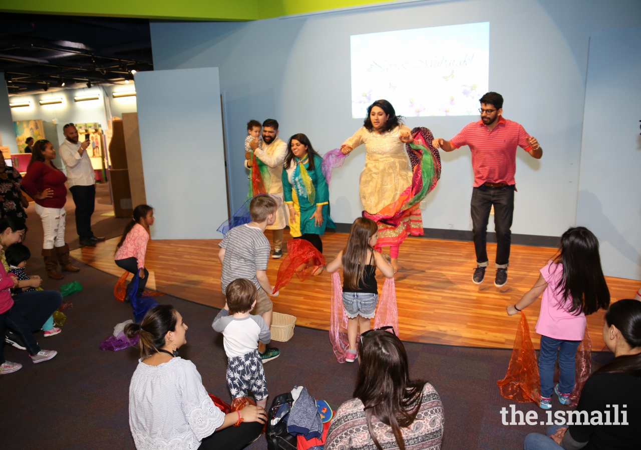 Museum-goers enjoy dancing to springtime nursery rhymes with Faisal Nayani, Afshan Lakhani, Zohra Nayani, and Asif Lakhani.