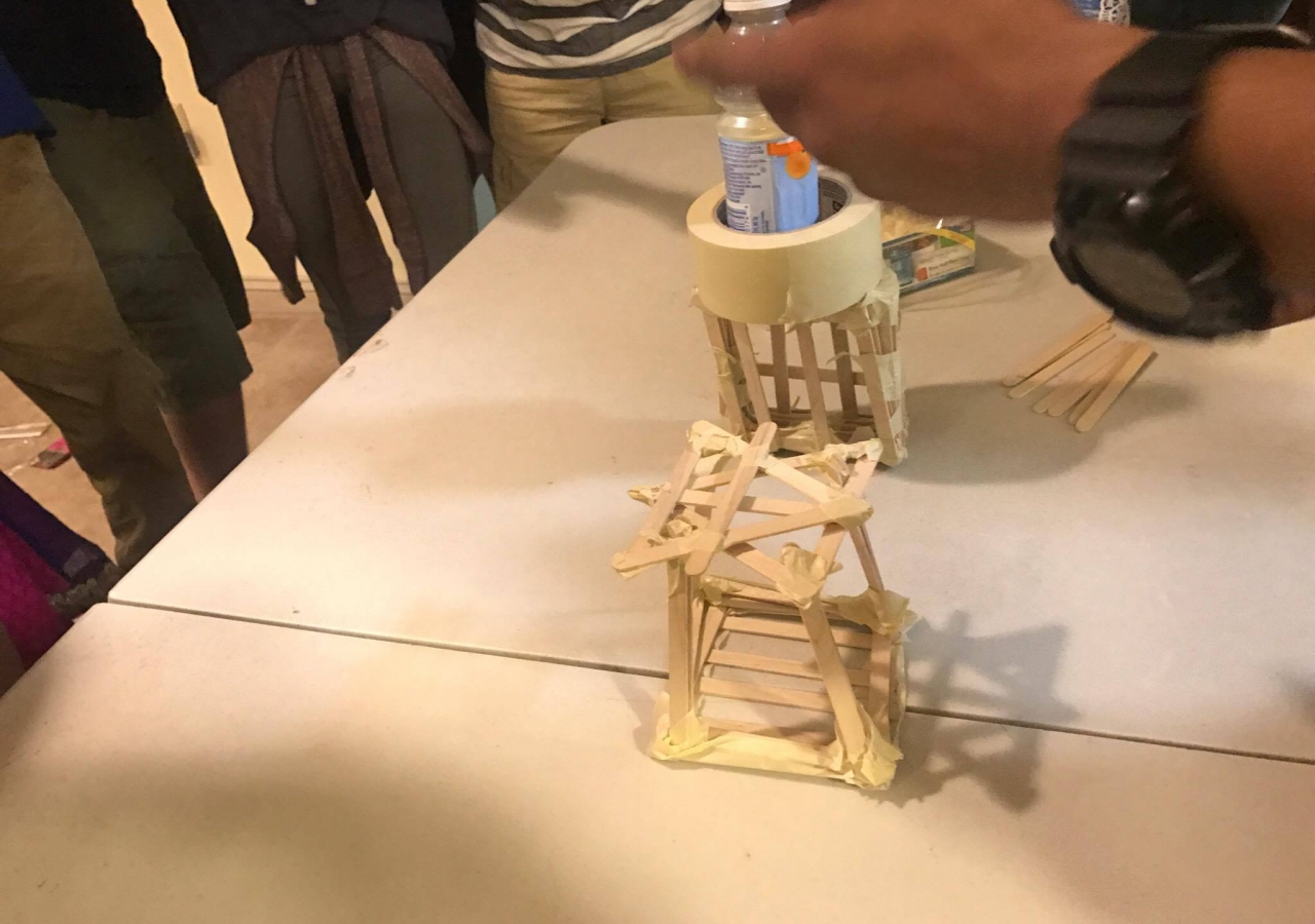 Students in New York Headquarters Jamatkhana build towers using popsicle sticks. 