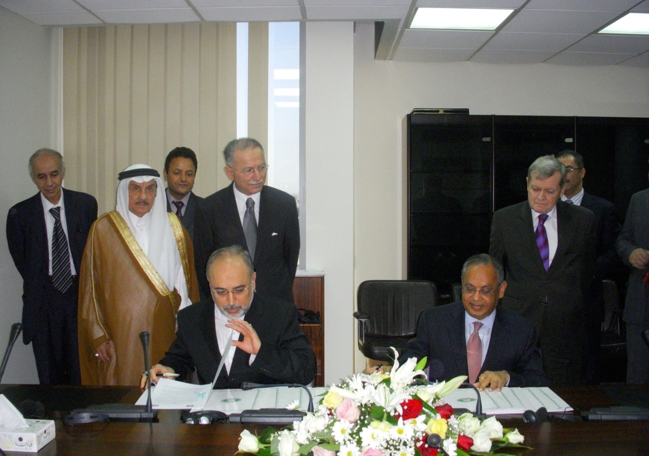 Sada Cumber signing a document with the Organization of the Islamic Conference (OIC).