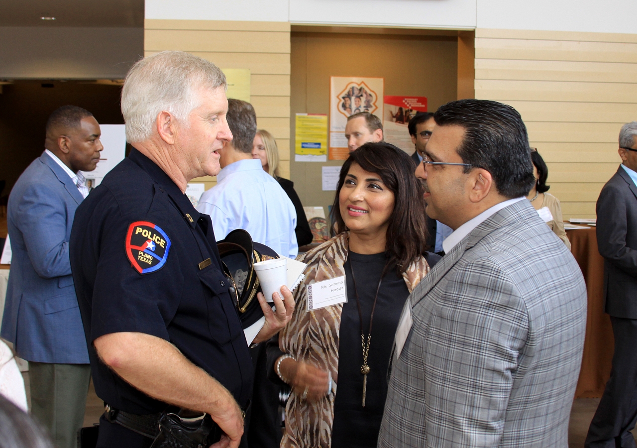 Plano Police Officer Tower speaks with President Nizar Didarali and Communications Coordinator Samina Hooda during the Open House at Plano Jamatkhana.