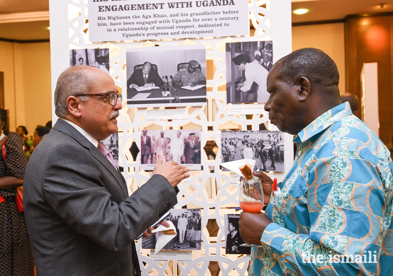 Ismaili Council for Uganda President Minaz Jamal (left) discusses one of the exhibition panels at the AKDN-hosted lecture on the Buganda Kingdom.