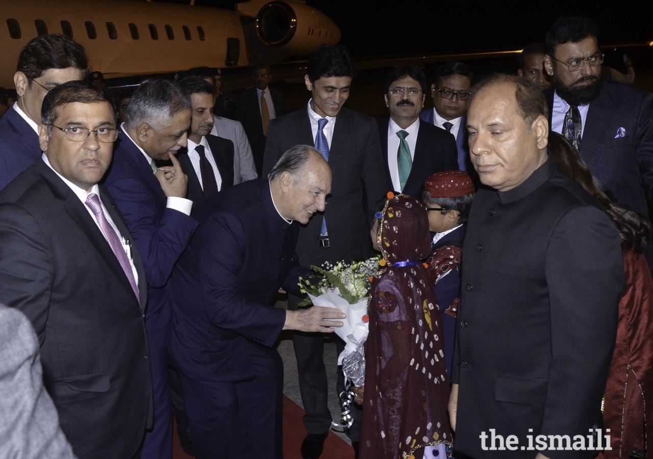 Mawlana Hazar Imam is presented with a bouquet of flowers upon his arrival in Karachi