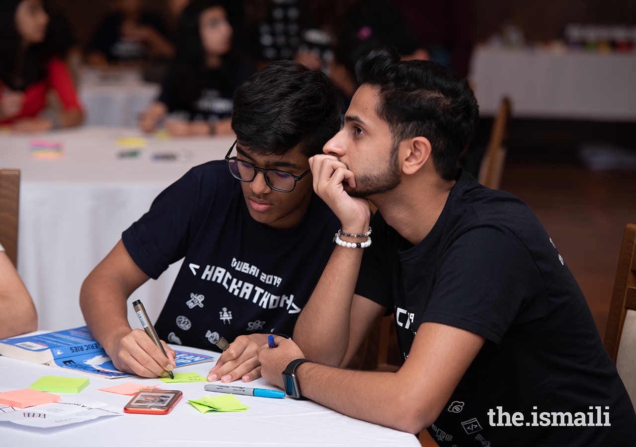 Hackathon Dubai participants contemplate solutions to real-world technological problems.