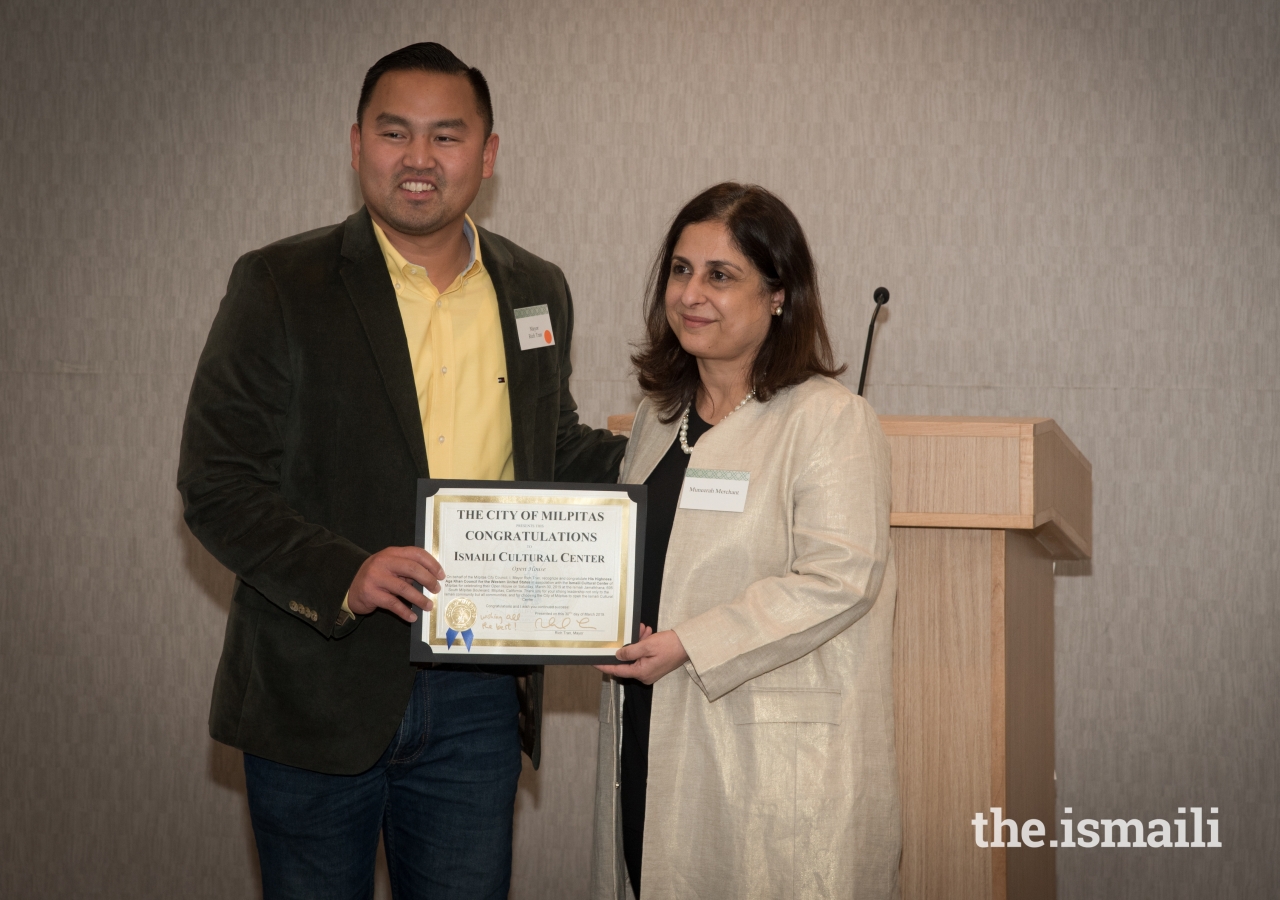 President Muneerah Merchant accepting a congratulatory letter from Mayor Richard Tran of the City of Milpitas.