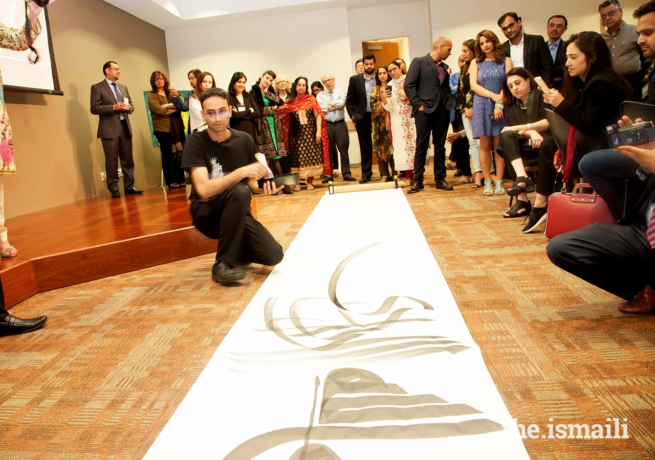 Musicalligrapher Bahman Panahi illustrating his work at Plano Jamatkhana during the Art Symposium dinner.