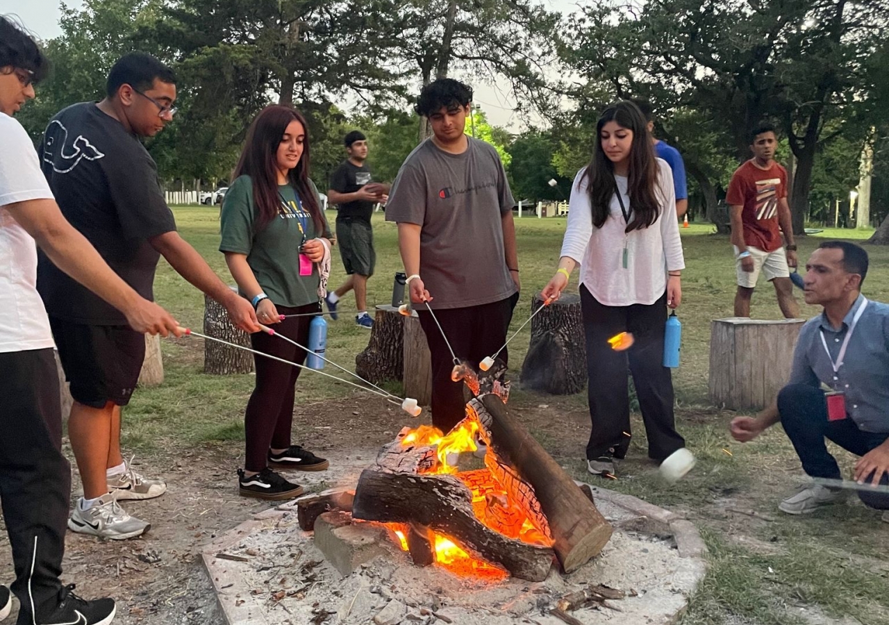 Students partake in community-building around the bonfire, where STEP teachers share stories from the curriculum and get to know their students.
