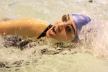 A swimmer fights hard to reach the end of a relay.  