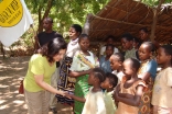 Shahinoor M. Visram, Managing Trustee of the Sun n Sand Trust, greets children in the village of Kikambala, Kenya where the Visram family has made important contributions to combating human trafficking and improving quality of life in the local community.