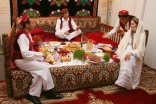 A family illustrates a traditional Tajik Navroz meal according to the “haft-shin” and “haft-sin” traditions.  
