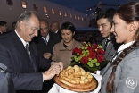 Mawlana Hazar Imam is presented with a traditional offering of non (bread) by two students from the Aga Khan School in Osh. Gary Otte