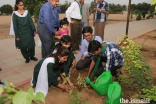 Girl Guides and Boy Scouts plant trees together to commemorate Pakistan's 71st Independence Day.