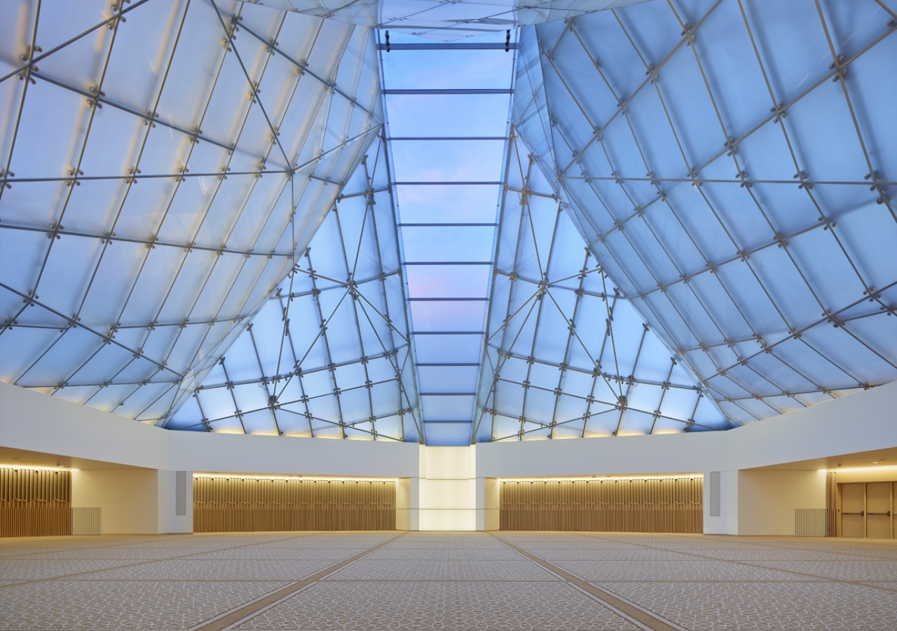 Inside the Jamatkhana, the central skylight panel descends to a white translucent onyx block. Shai Gil