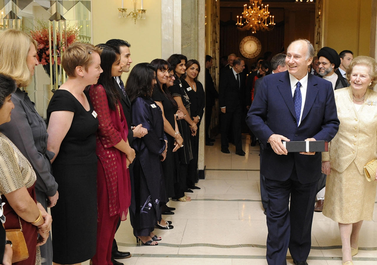 Flanked by Baroness Margaret Thatcher, former British Prime Minister, Mawlana Hazar Imam bids farewell to volunteers after the Imamat Dinner, London, 3 July 2008.