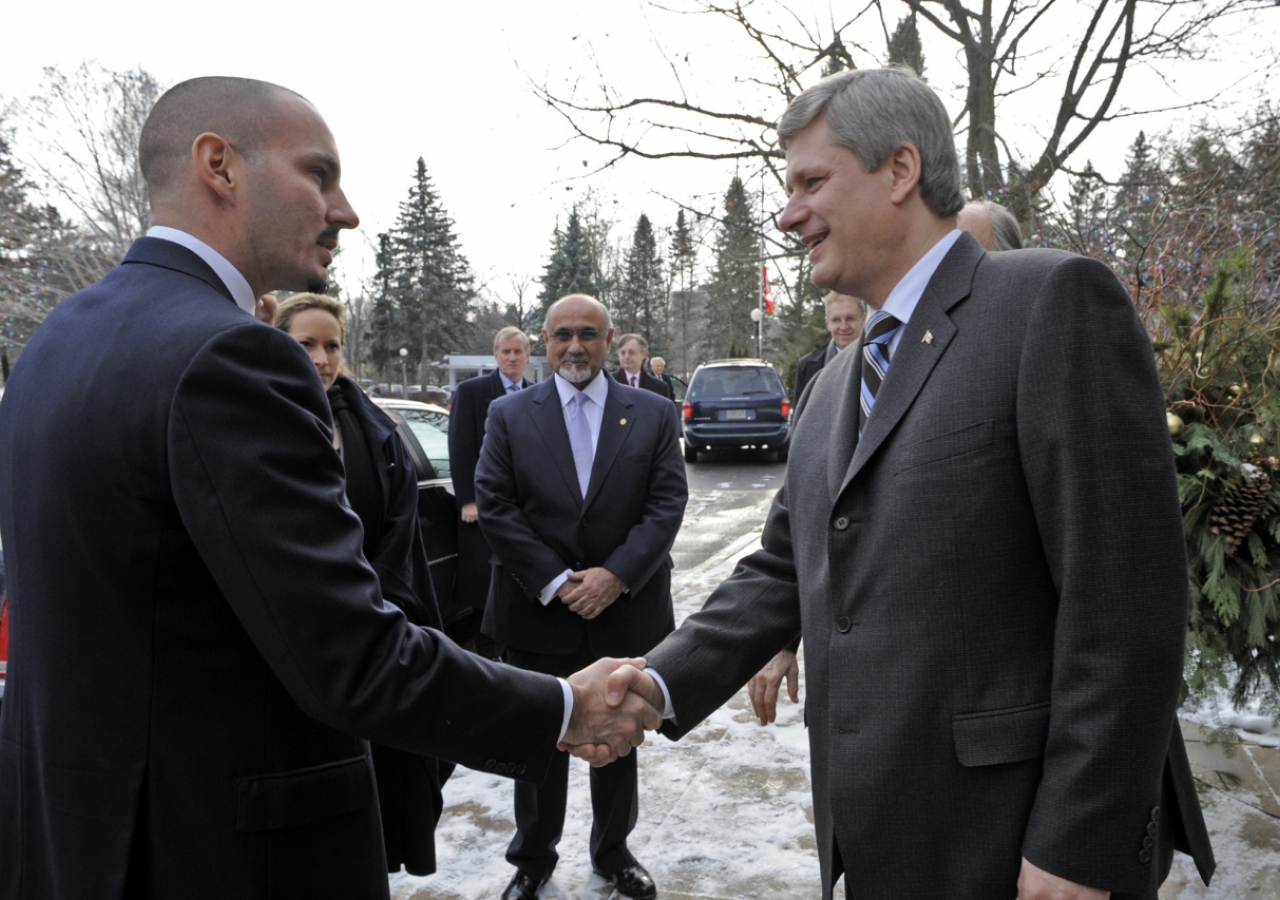Prime Minister Stephen Harper welcomes Prince Rahim to 24, Sussex Drive, as  President Mohamed Manji of the Ismaili Council for Canada looks on.  