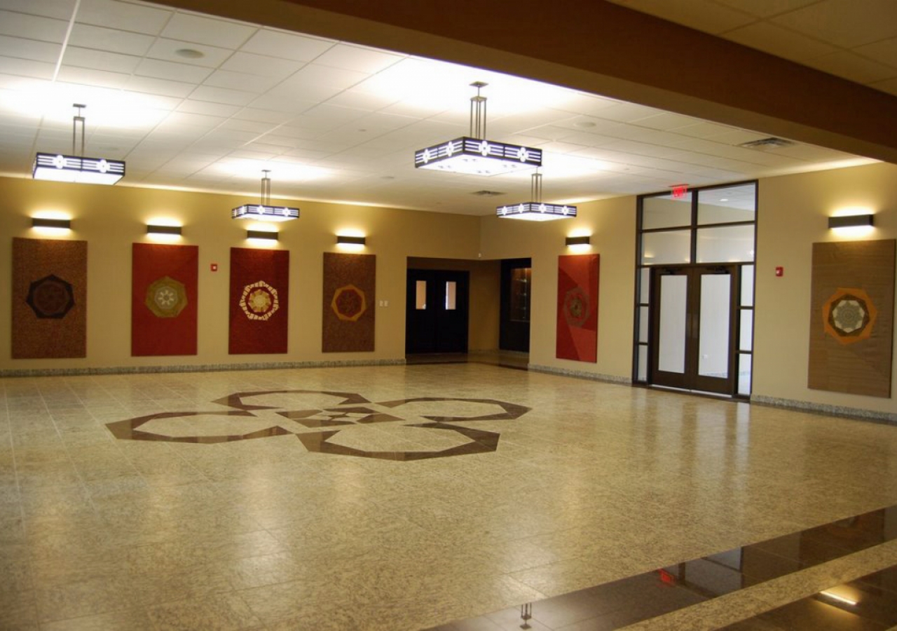 A heptagonal (seven-sided) motif was used throughout the building, and is apparent in the lobby. The hanging tapestries were created by volunteers in the Jamat.  