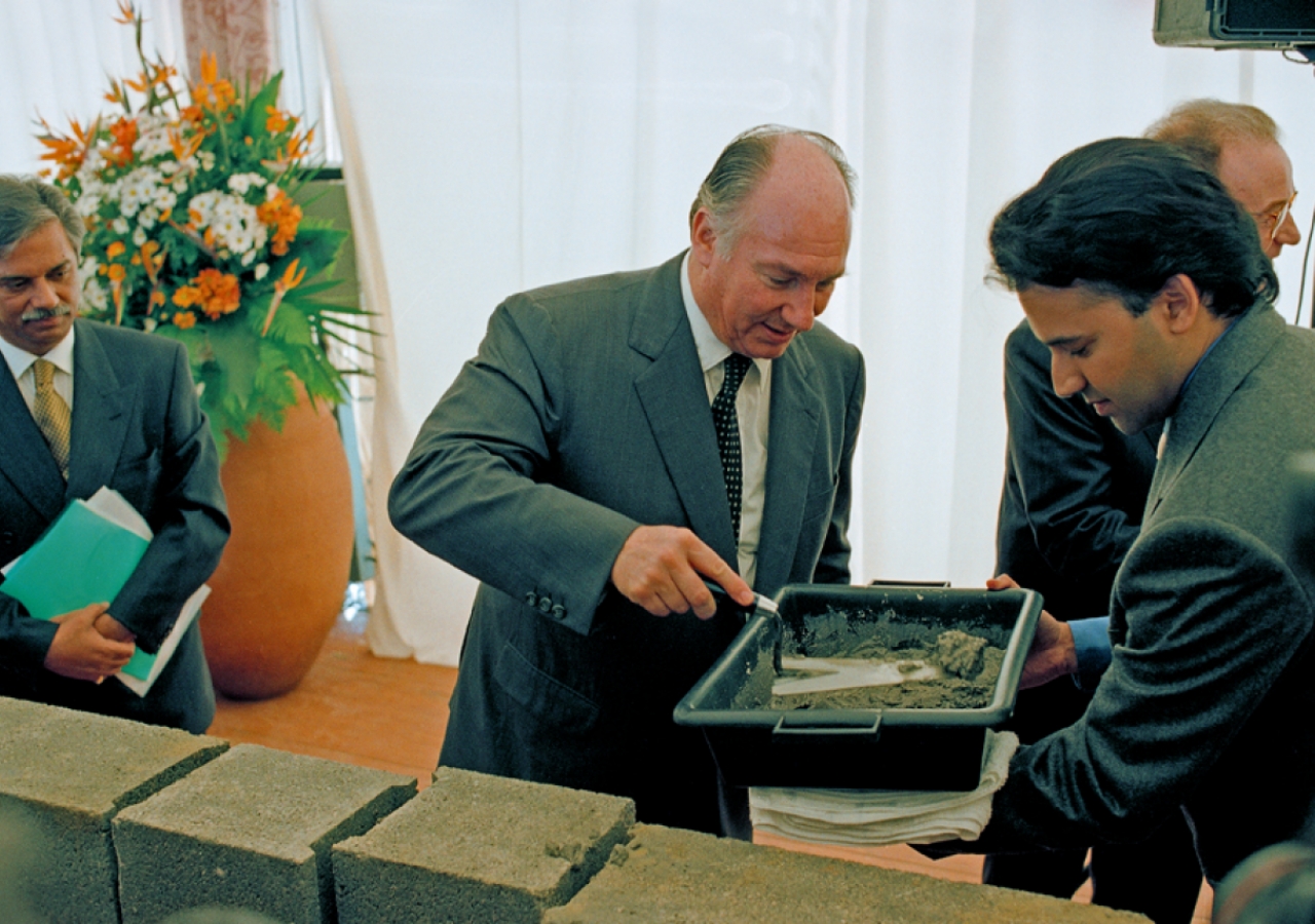 Mawlana Hazar Imam applies cement to brick as part of the Foundation Ceremony of the Ismaili Centre, Lisbon.