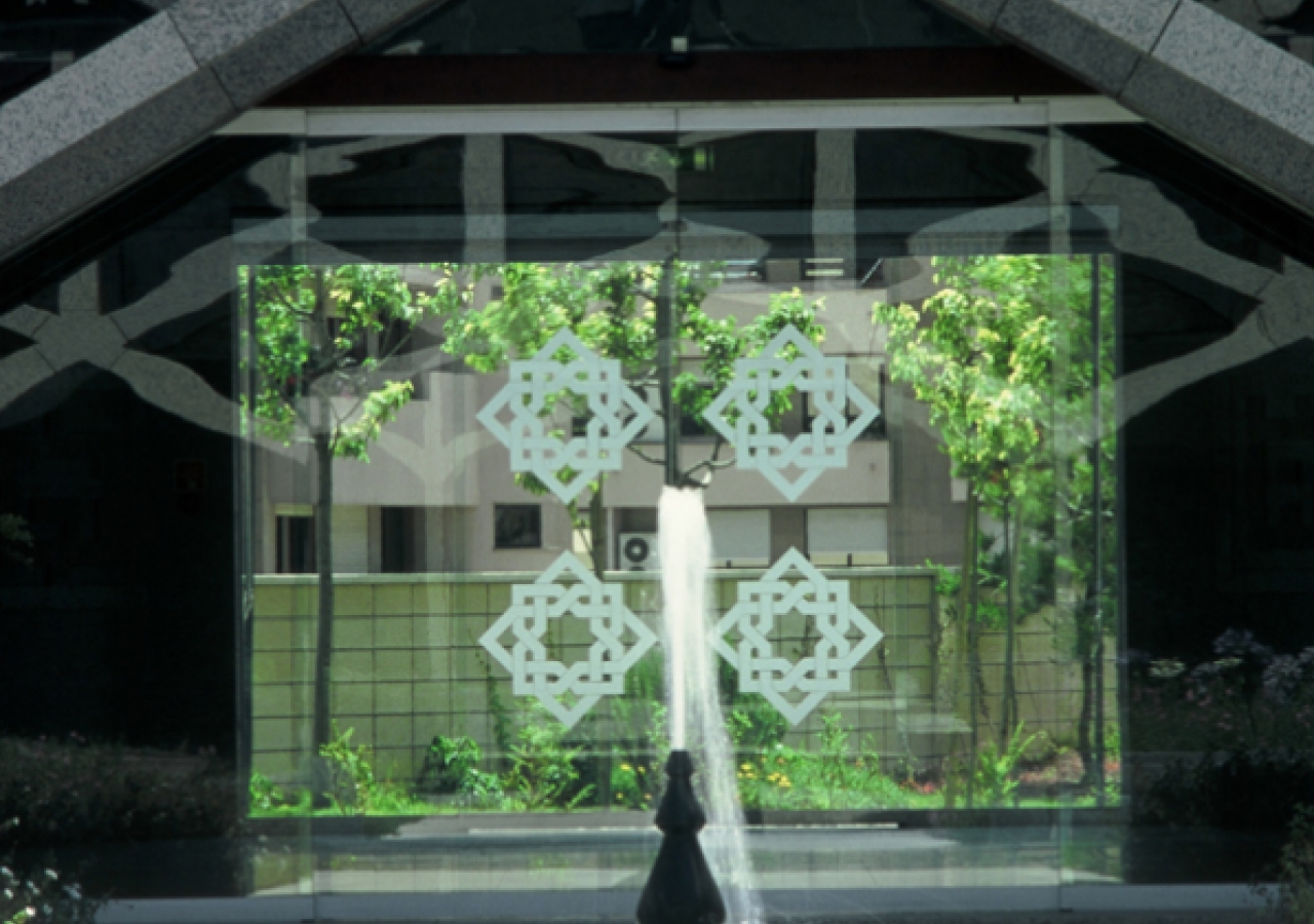 A courtyard fountain framed in granite lattice.